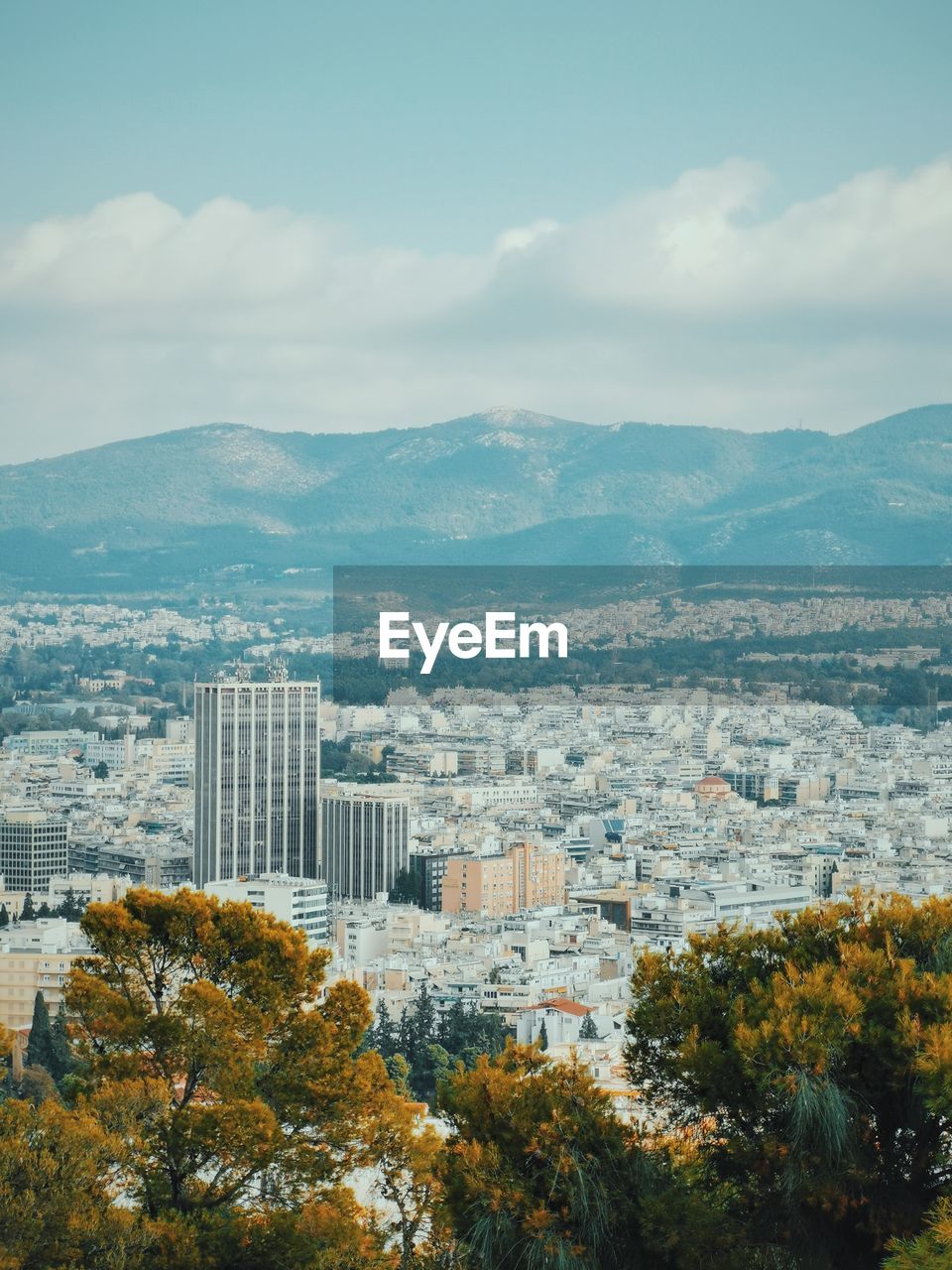 Photo of urban athens with hills in the distance 