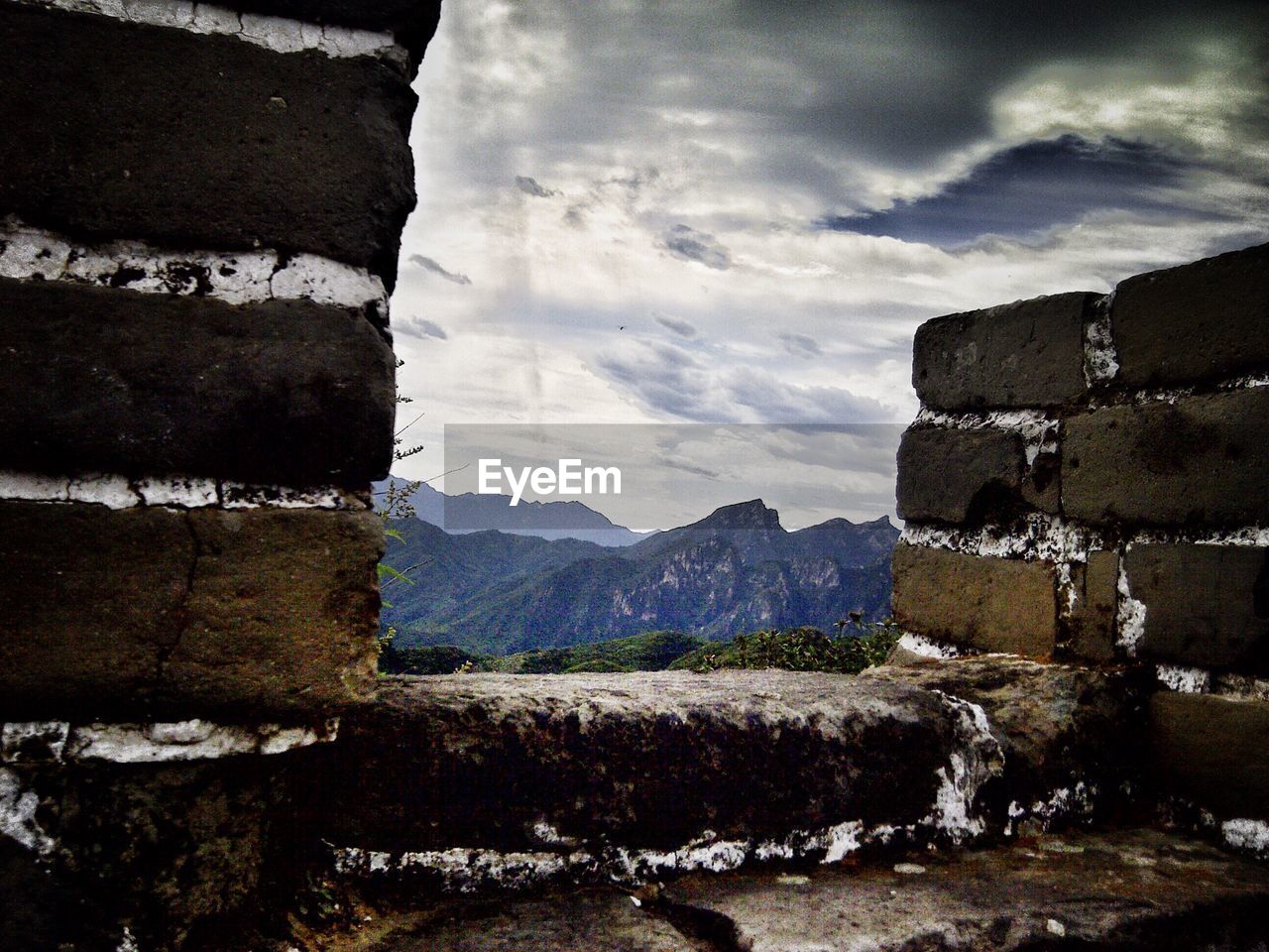 Clouds over mountains viewed from wall