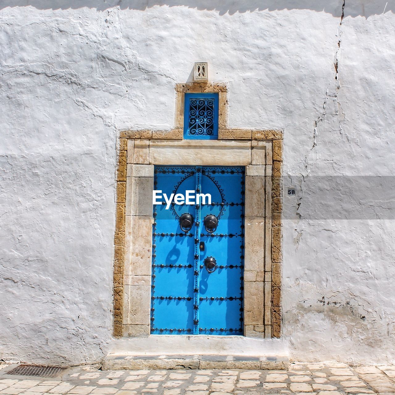 Closed wooden door with door knockers