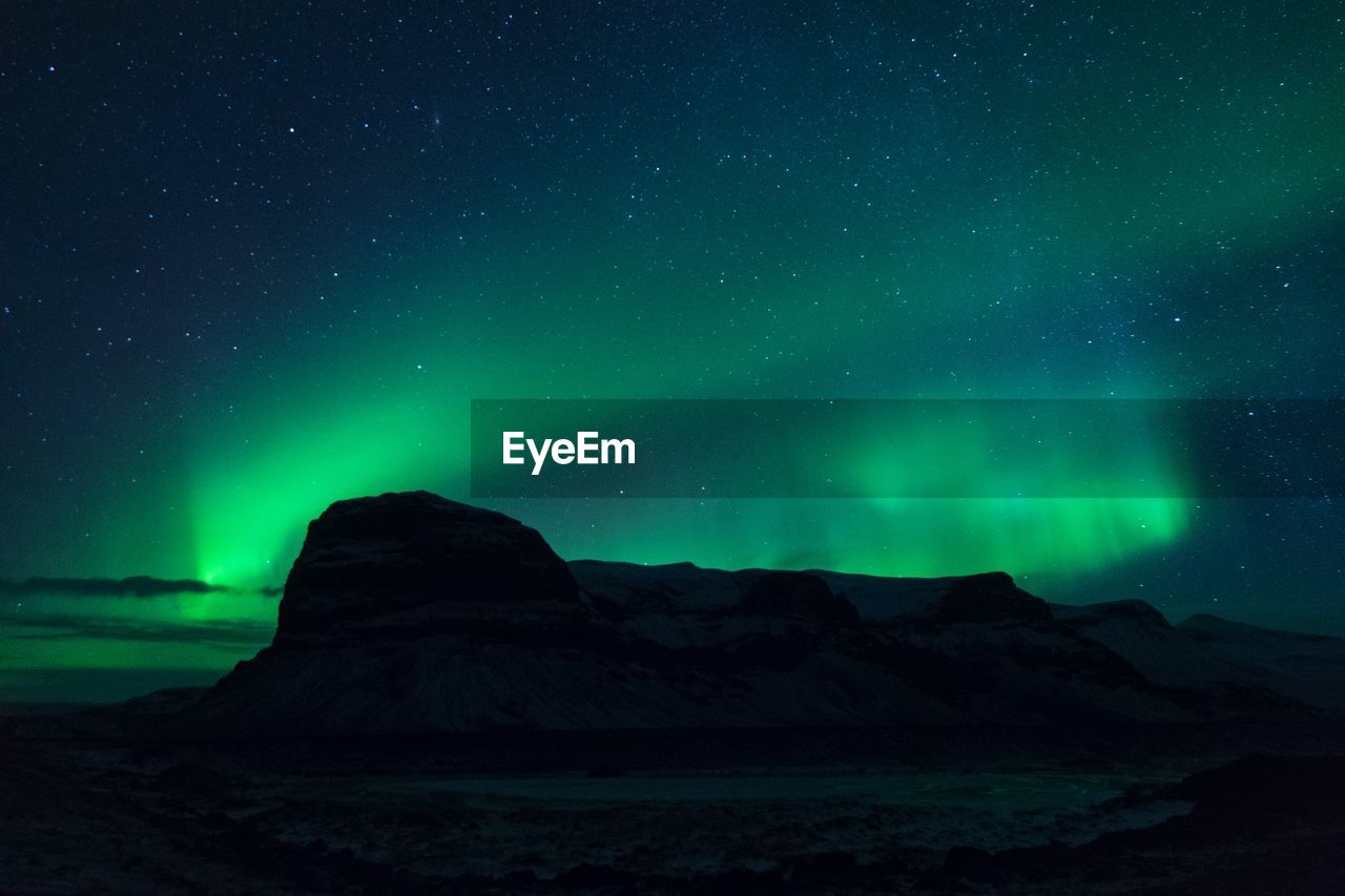 Scenic view of mountains against sky at night