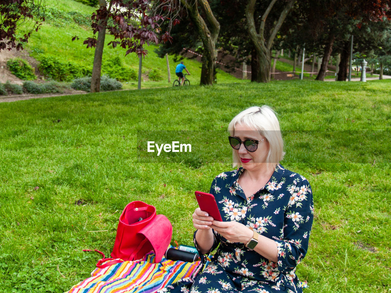 Young woman using mobile phone on field