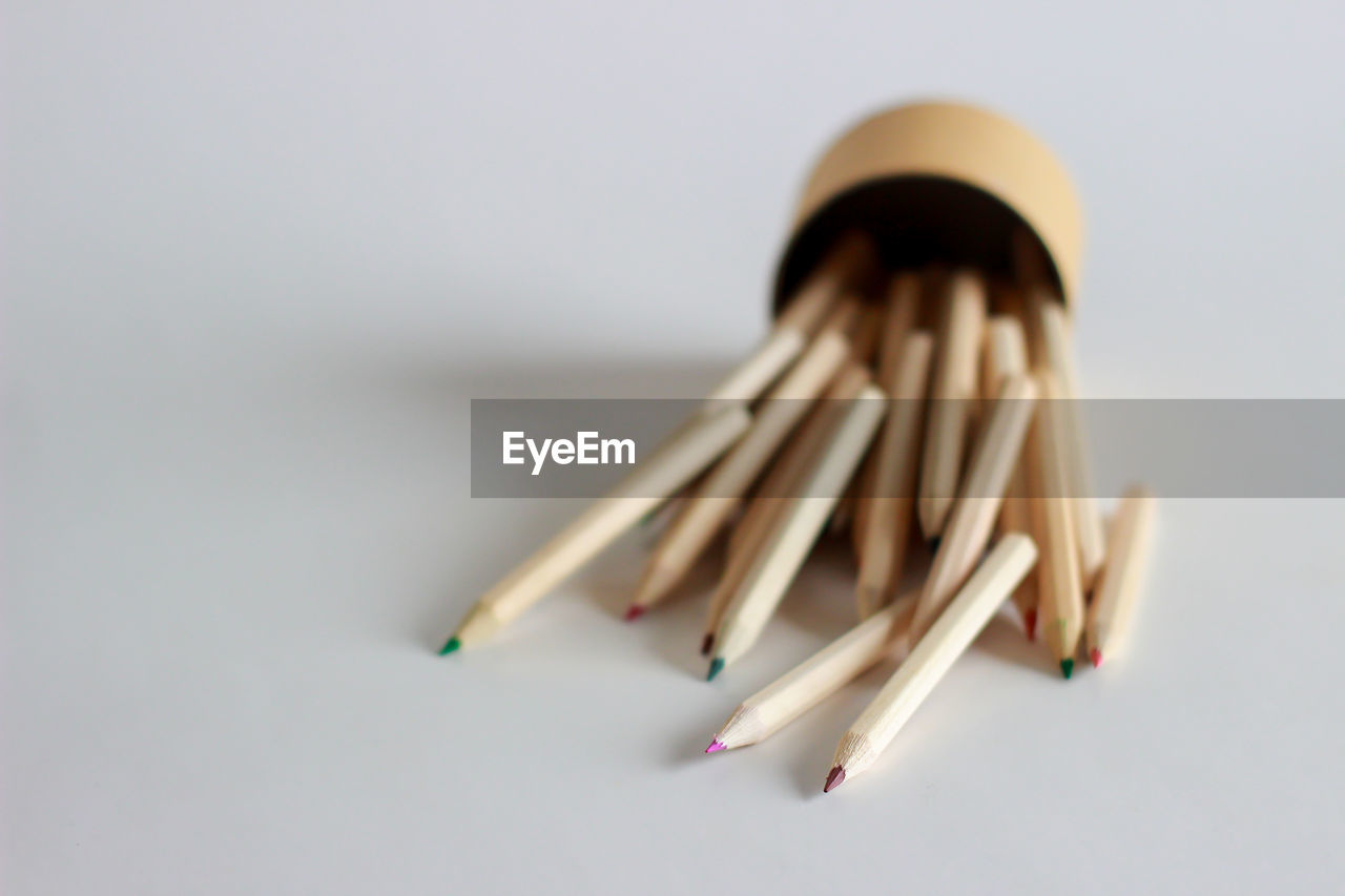 Close-up of colored pencils against white background