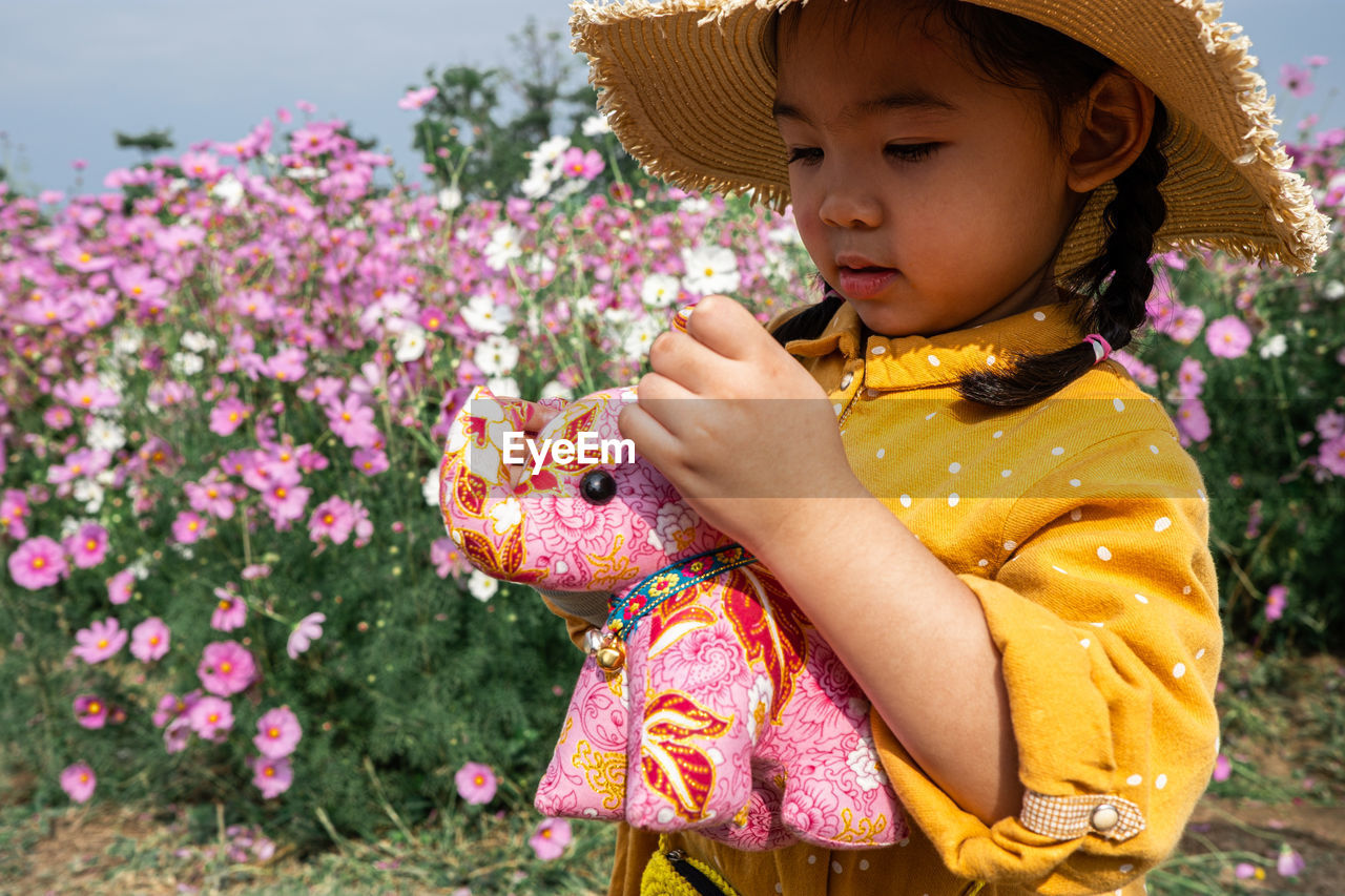 Cute childen yellow dress in the flower farm