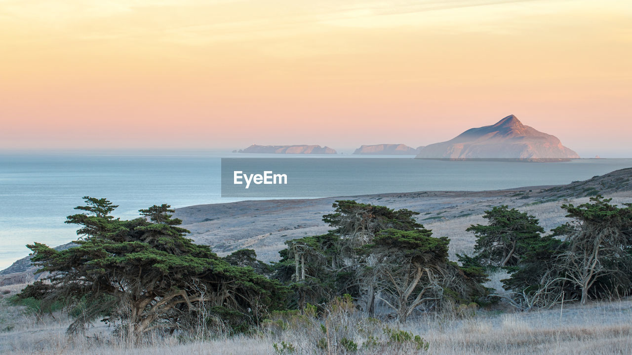 Scenic view of sea against sky at sunset