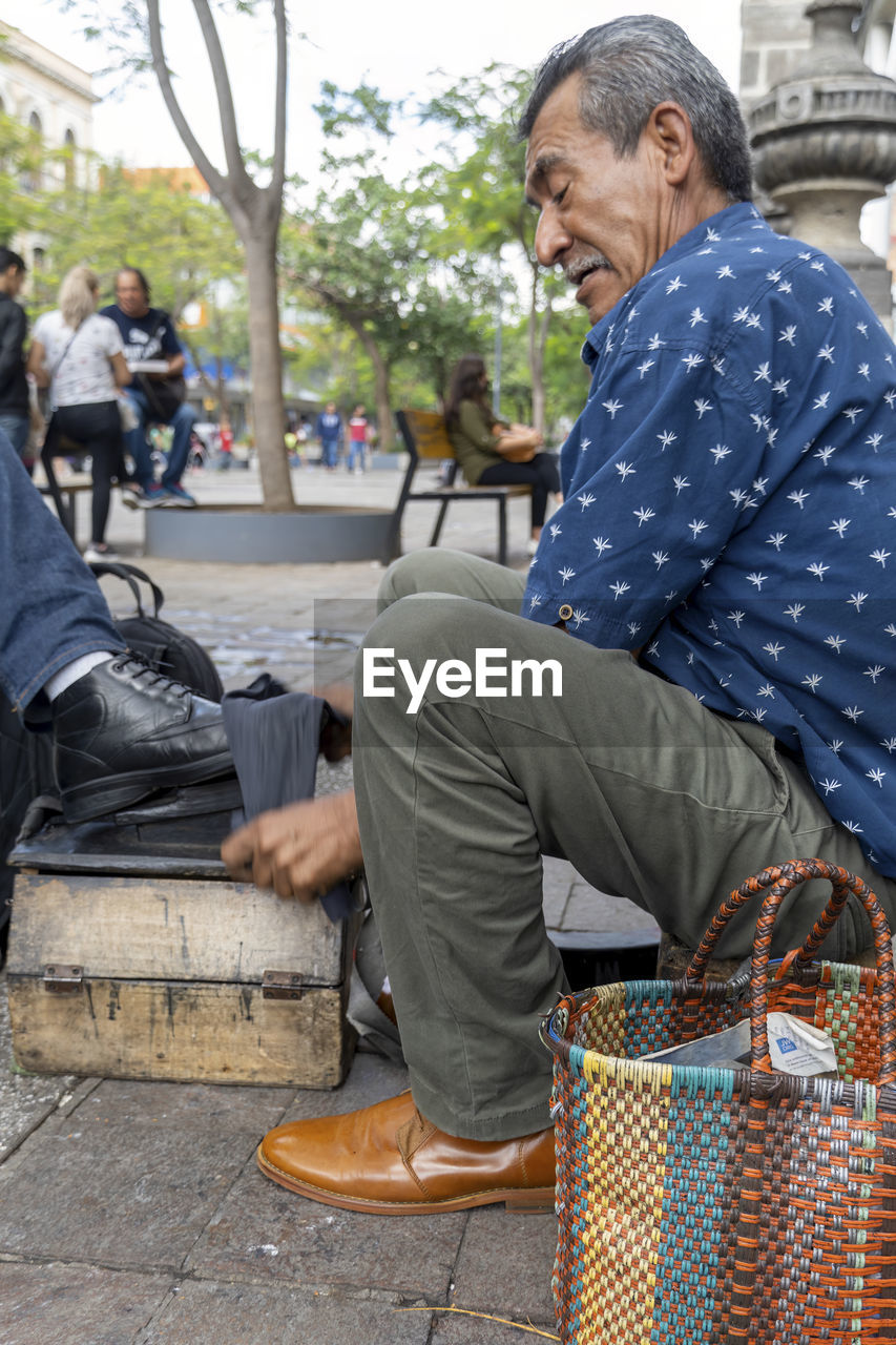 portrait of senior man sitting in baskets