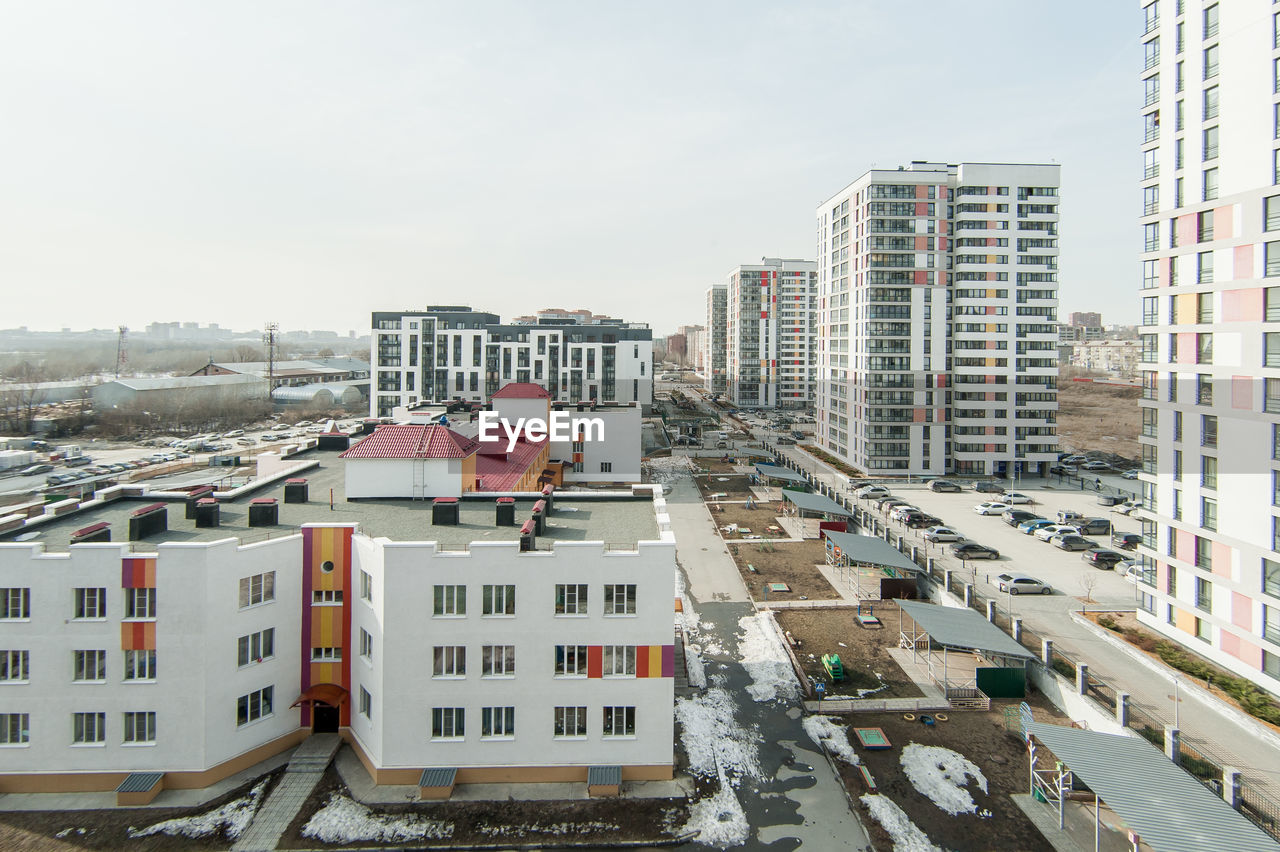 High angle view of buildings in city against sky