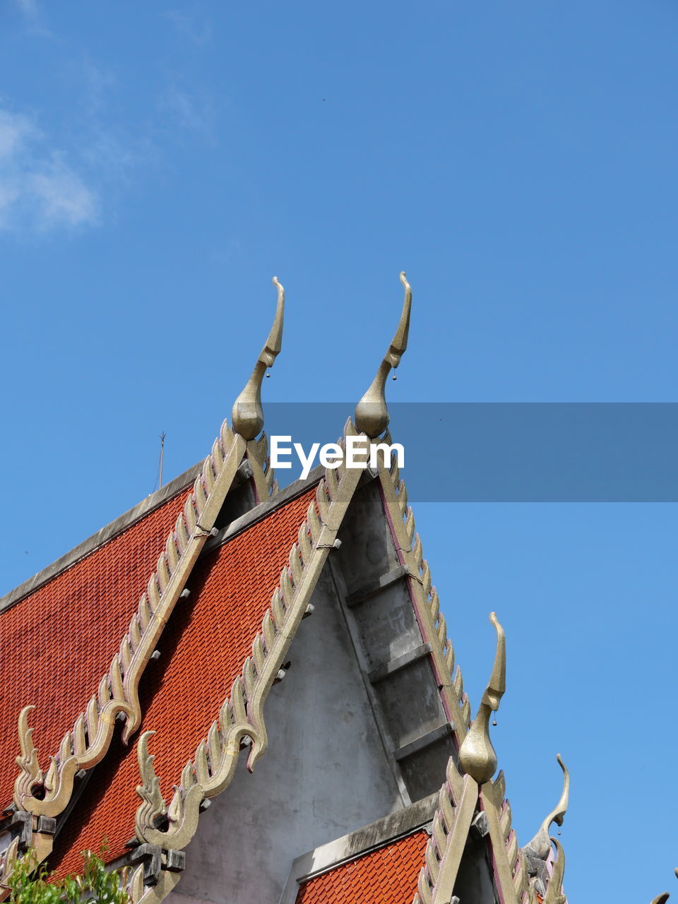 Low angle view of traditional temple against blue sky