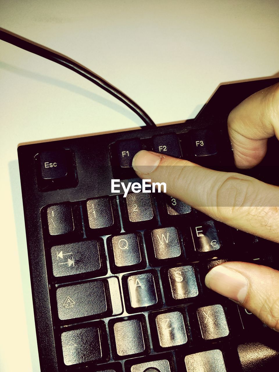 Cropped image of person typing computer keyboard