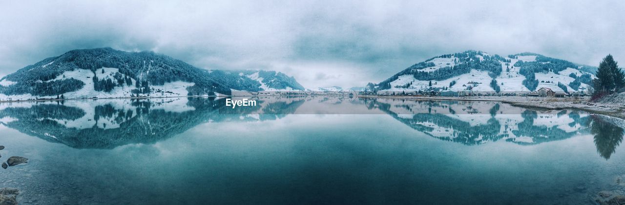 Panoramic view of lake and mountains during winter