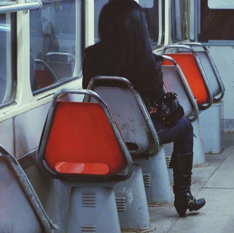 WOMAN SITTING ON SEAT