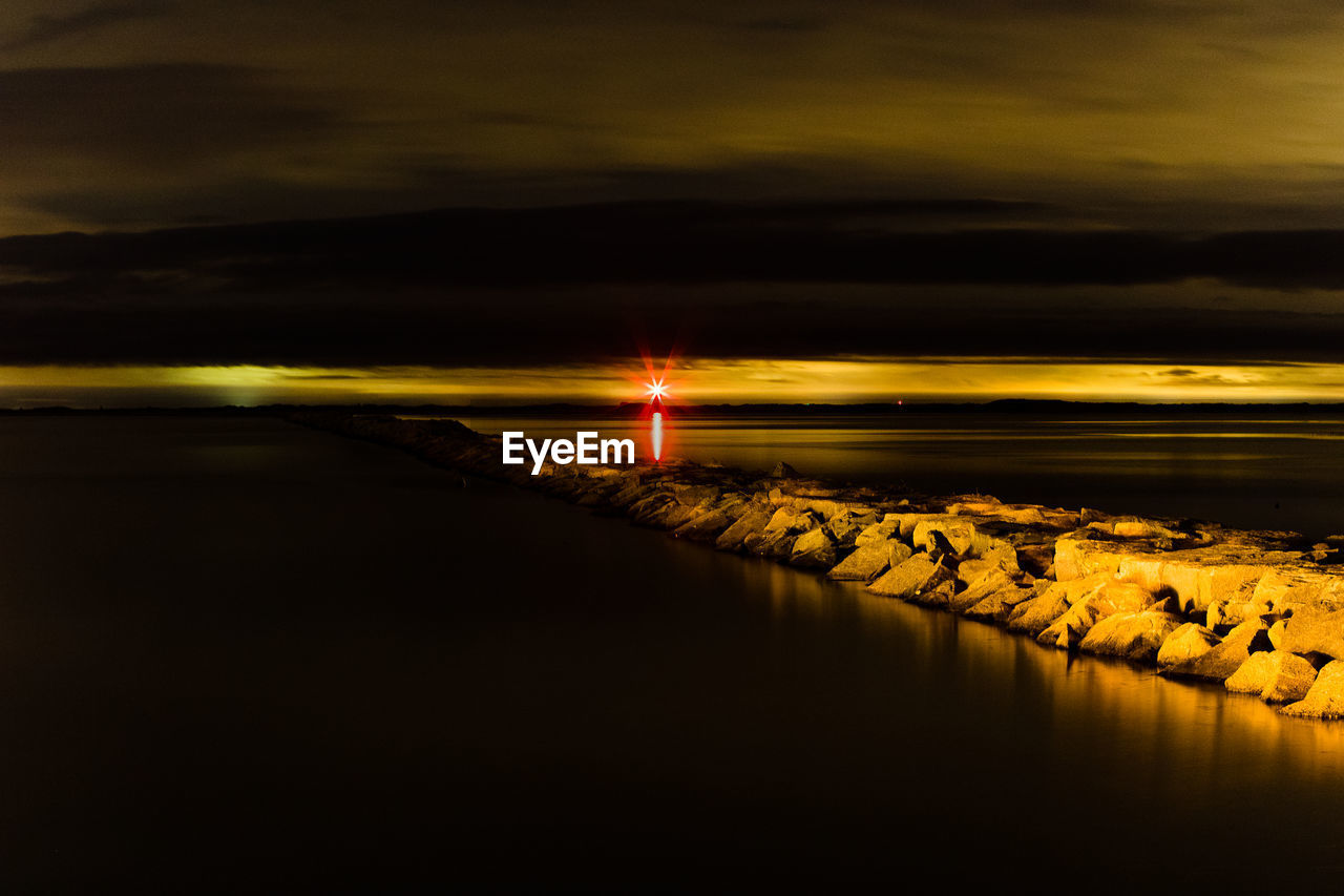 Scenic view of sea against sky at night