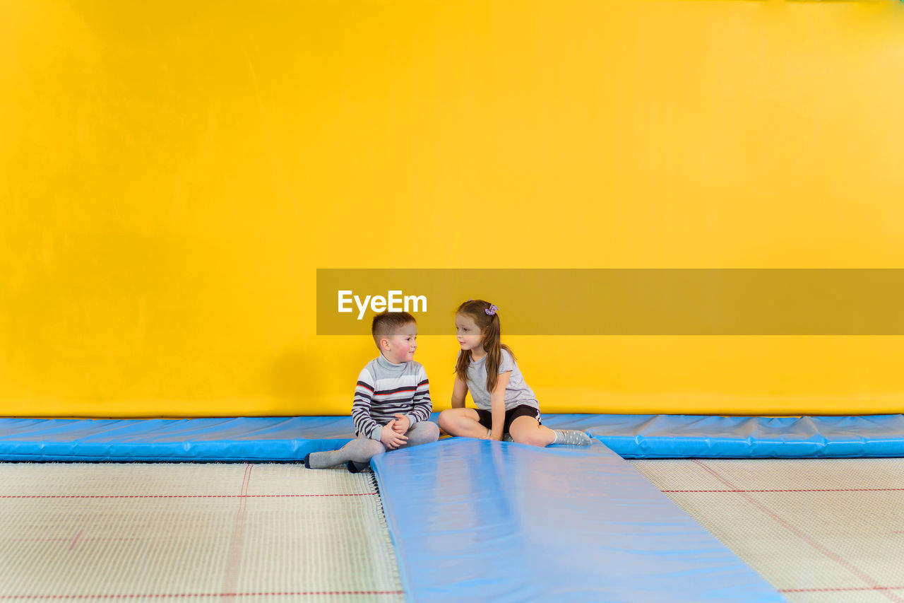 Rear view of people sitting in swimming pool