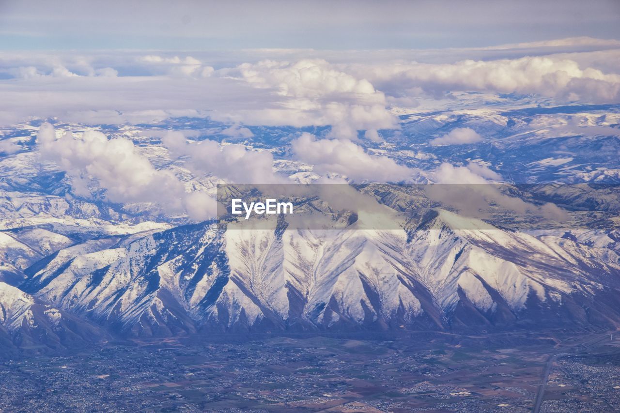 Aerial view of snowcapped mountains against sky