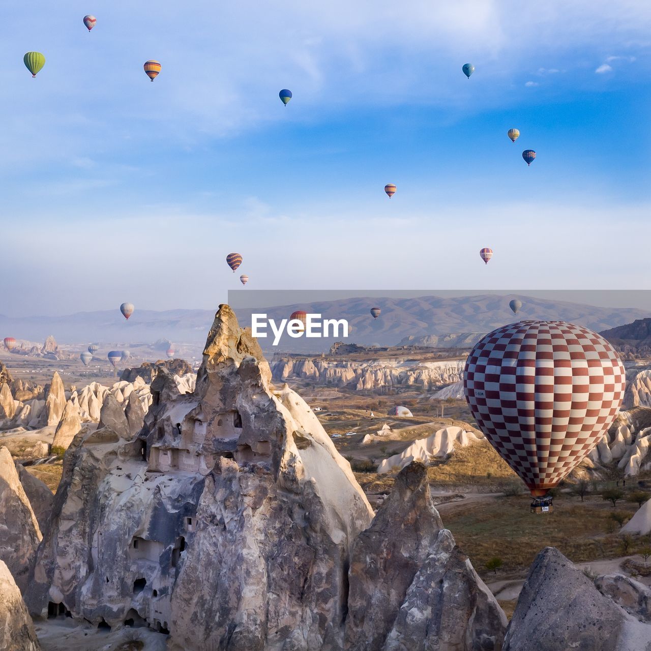 HOT AIR BALLOONS FLYING OVER ROCK