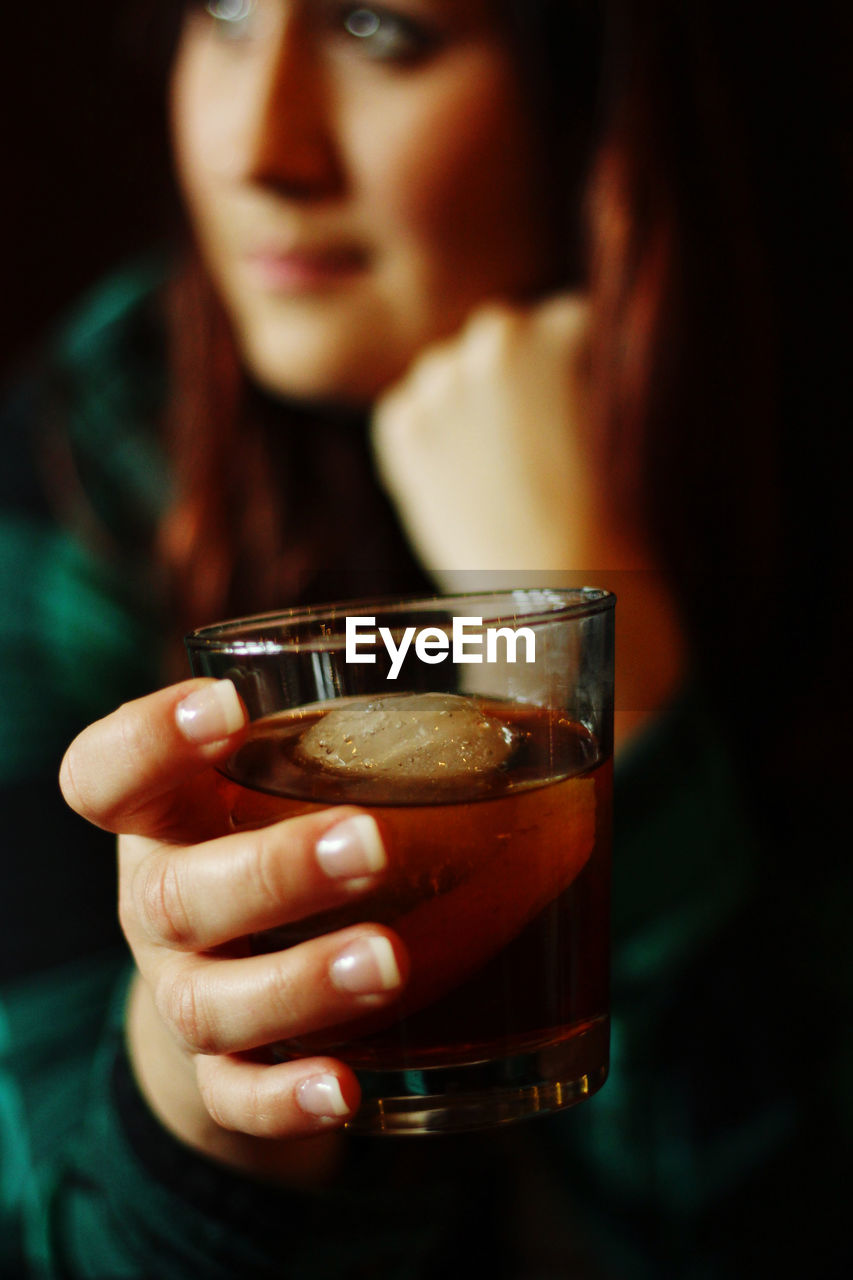 Close-up of woman drinking glass