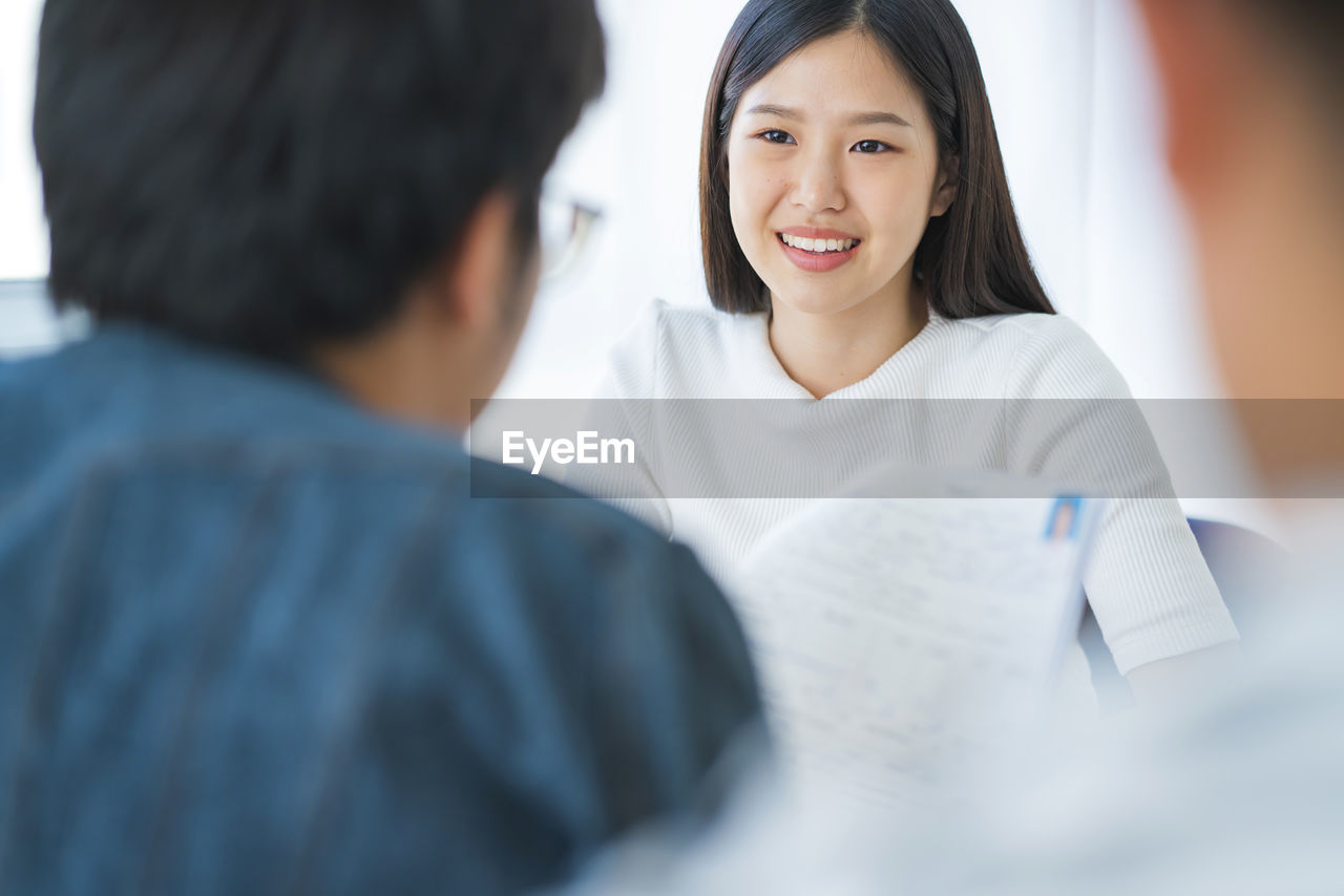 Manager taking interview of young woman at office