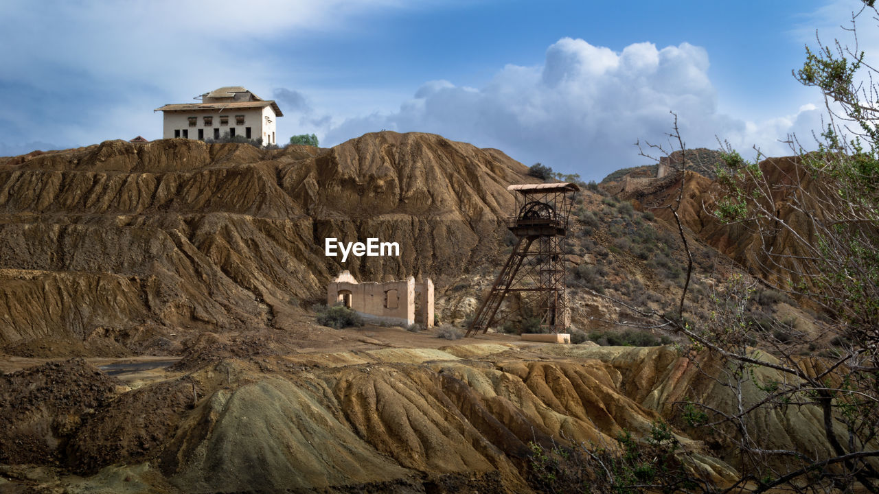 PANORAMIC VIEW OF ROCK FORMATIONS ON LANDSCAPE AGAINST SKY