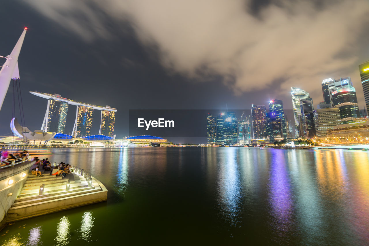 Illuminated marina bay sands against sky at dusk