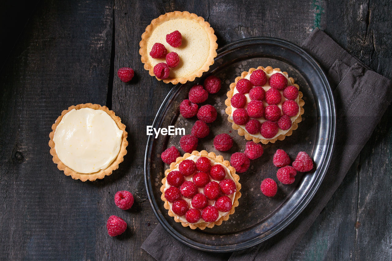 Directly above shot of tarts in tray on table