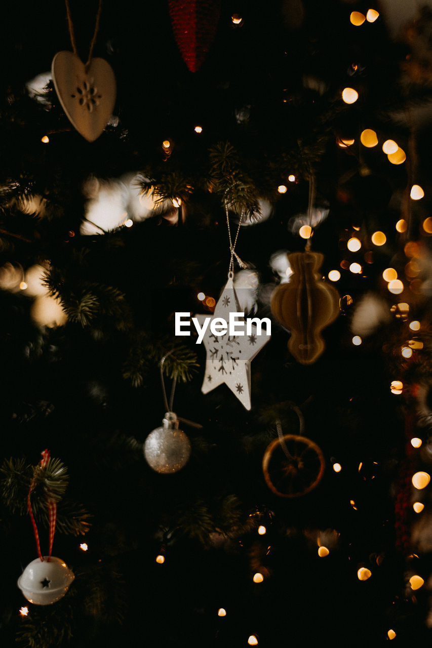 Decorations and ornaments hanging on a christmas tree in the festive season, indoors