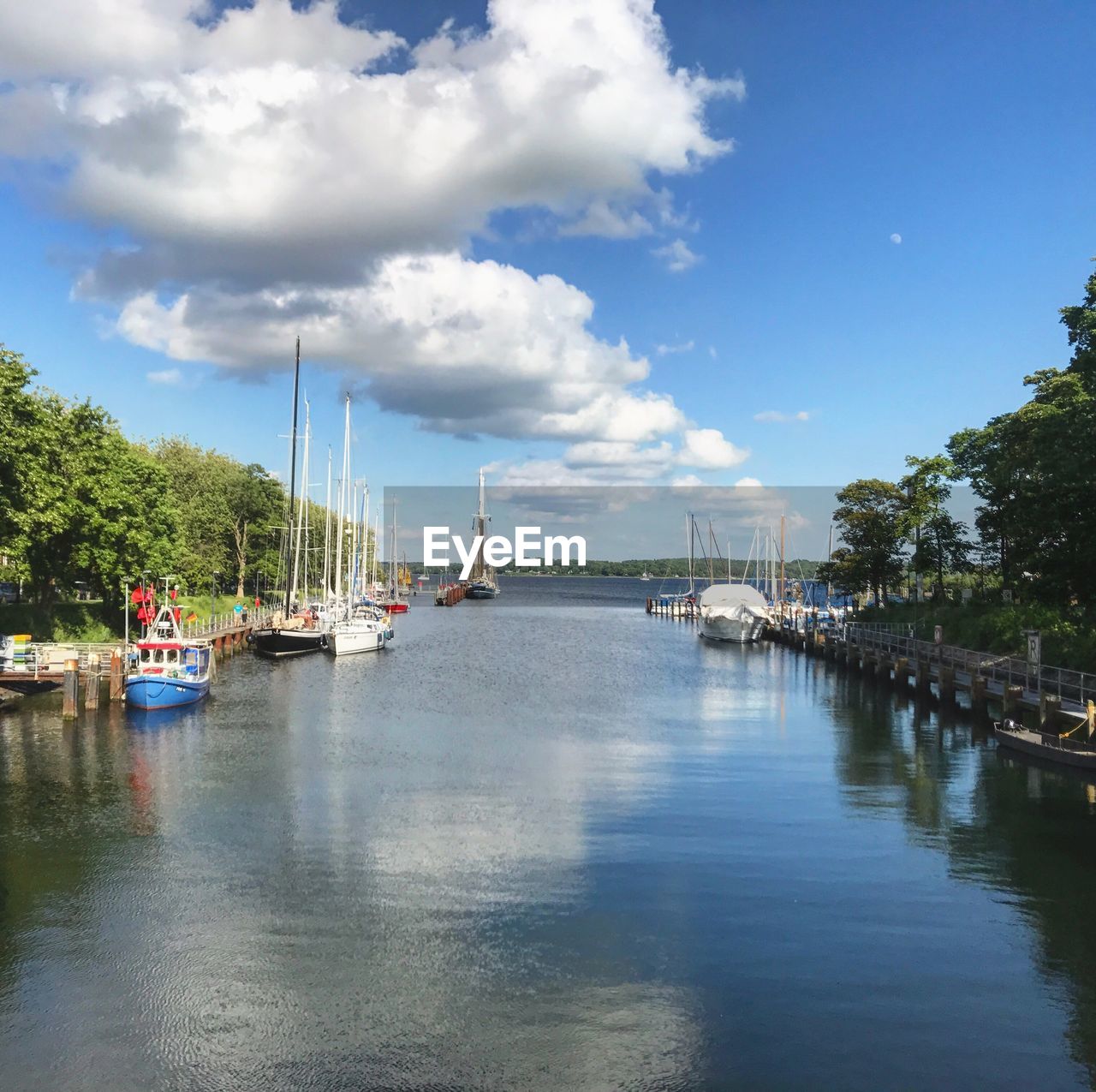 Boats moored on river against sky