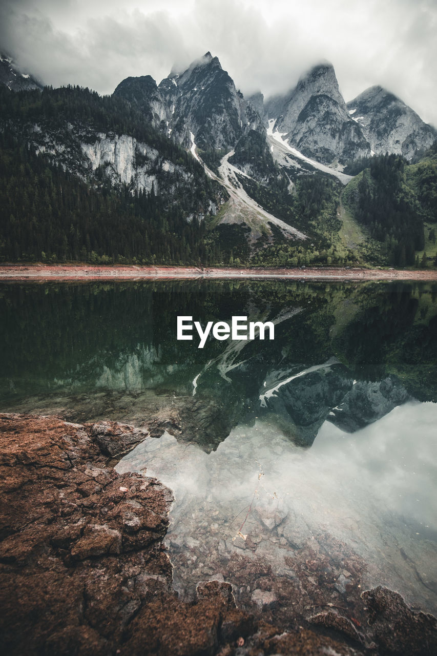 SCENIC VIEW OF LAKE AGAINST MOUNTAIN RANGE