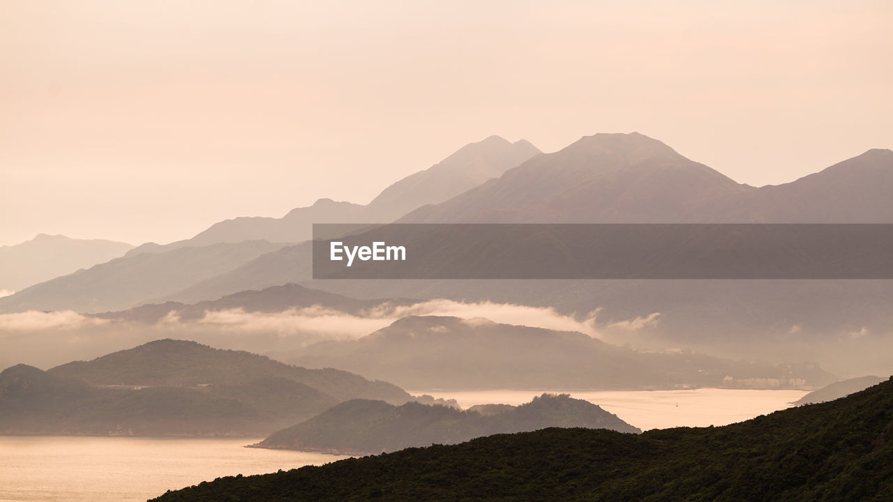 Hong kong cargo ship nuatical transportation  vessel ocean beautiful sunset mountain landscape