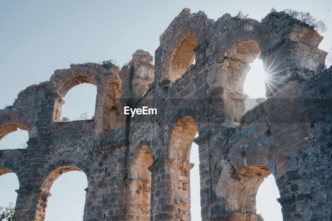 Low angle view of old ruins against clear sky