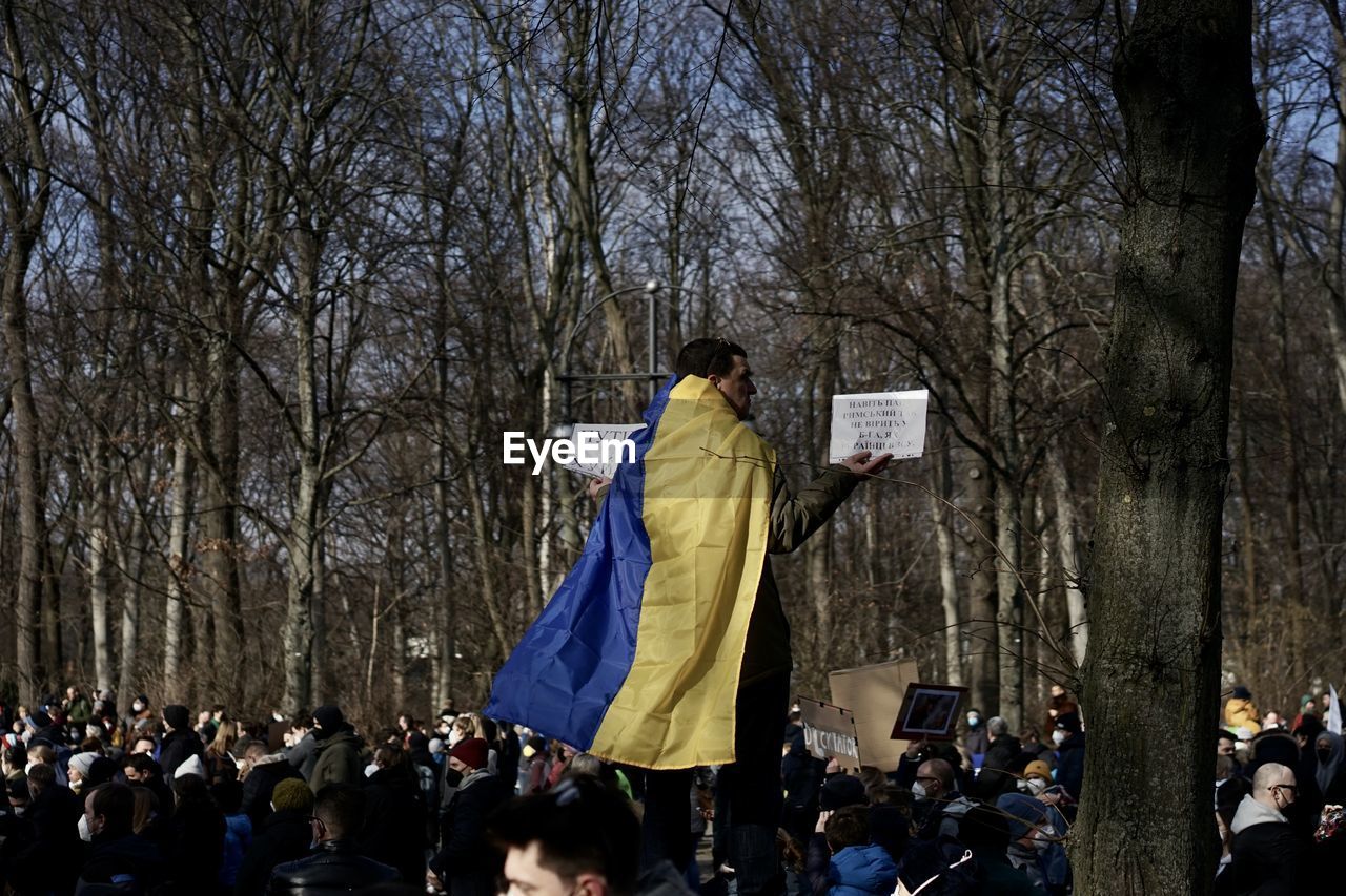 Rear view of man protesting with banner