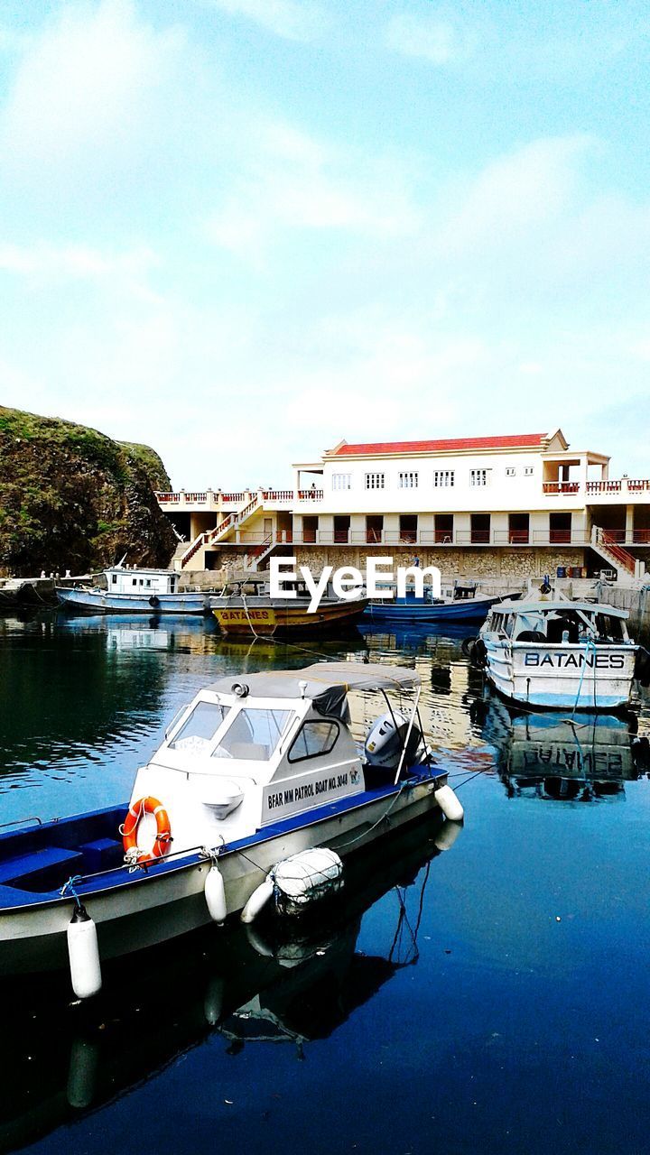 Boats in river with buildings in background