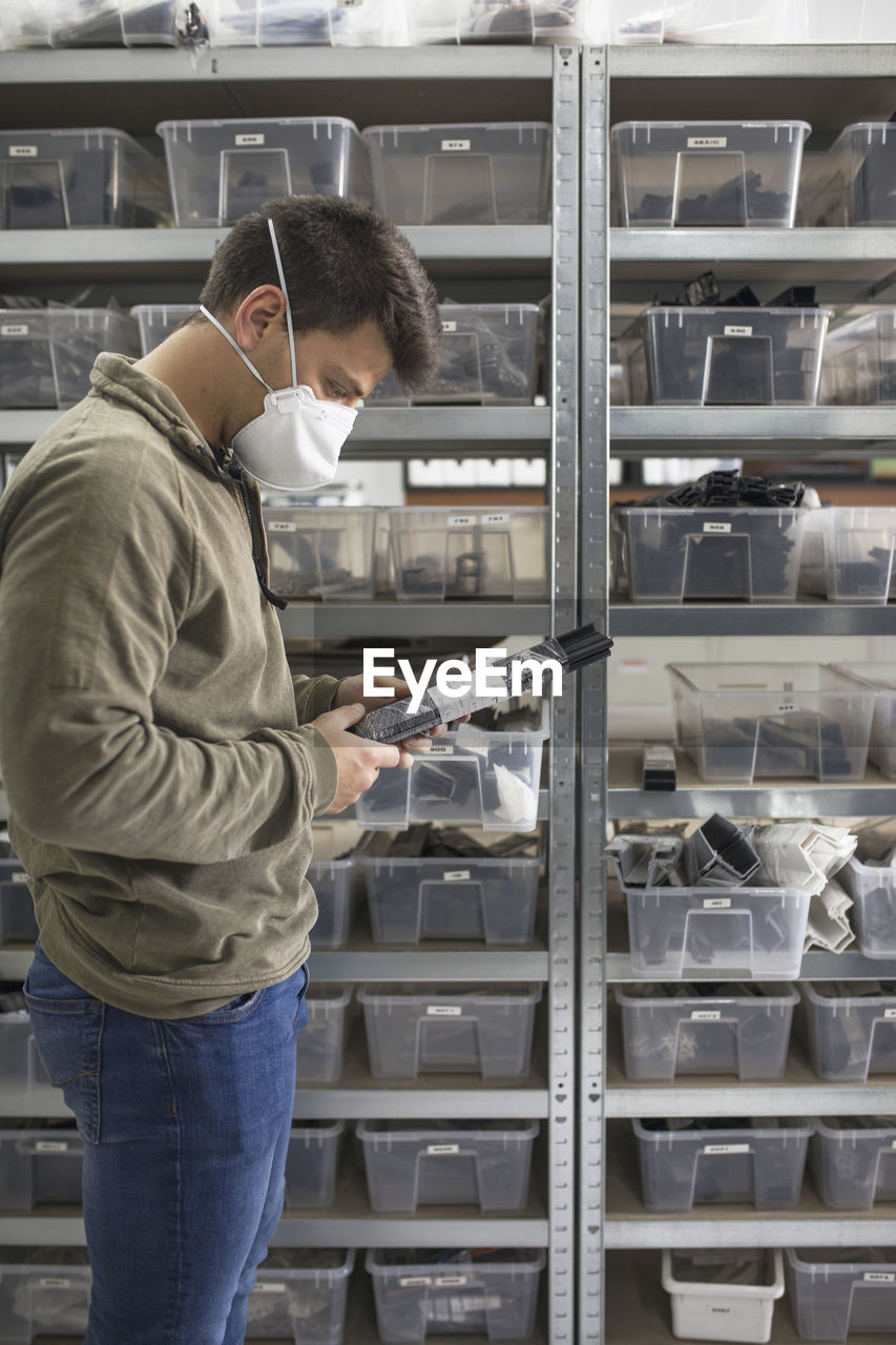 Man working in factory with mask