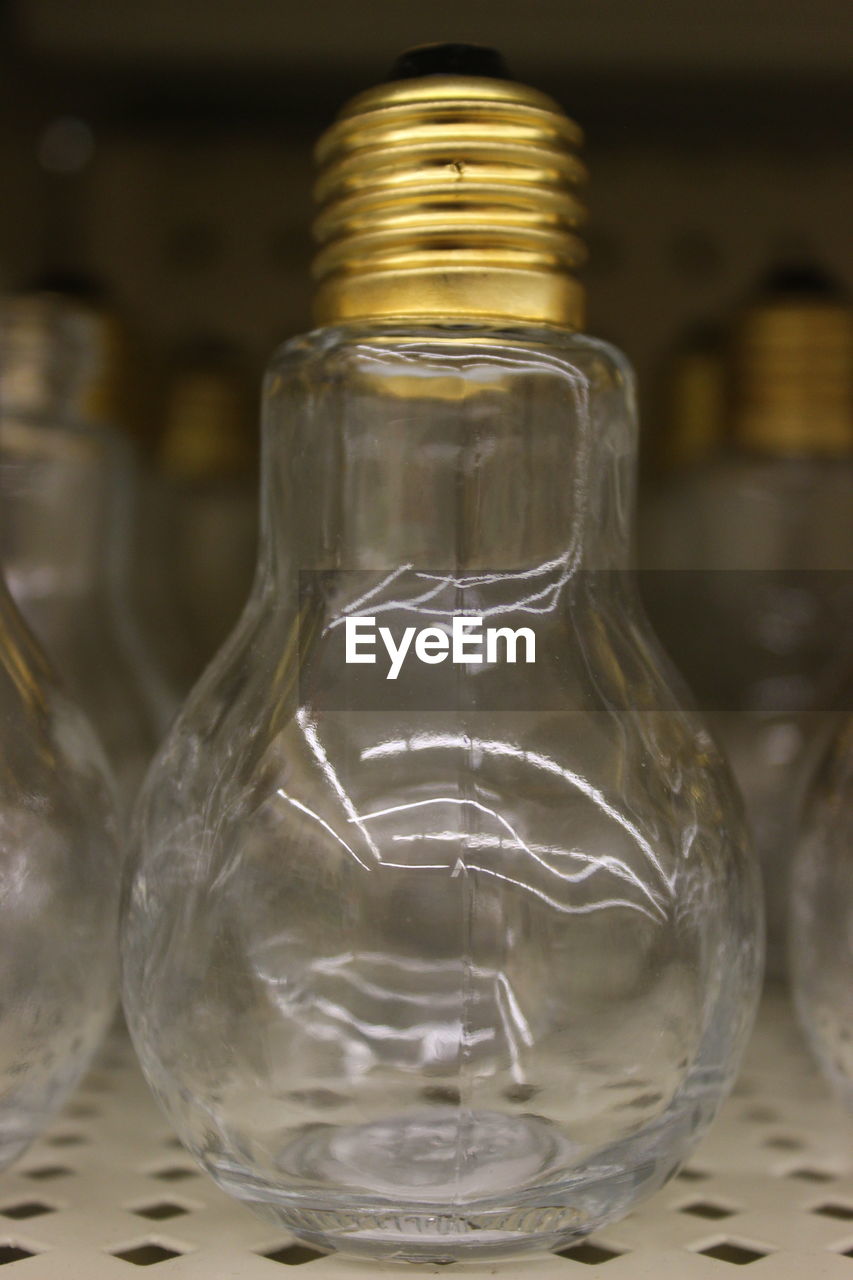 CLOSE-UP OF DRINKING GLASS IN JAR