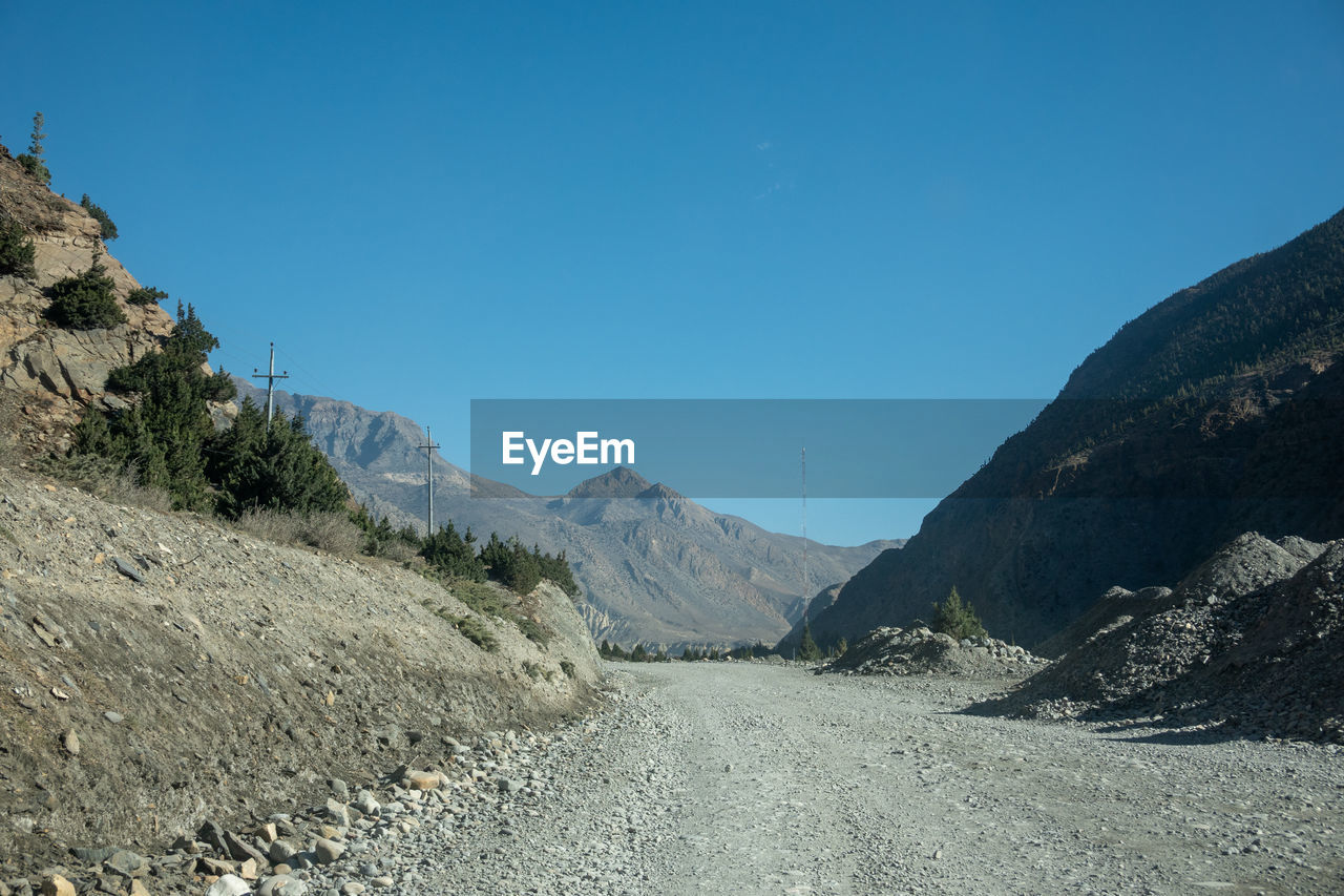 Scenic view of mountains against clear blue sky