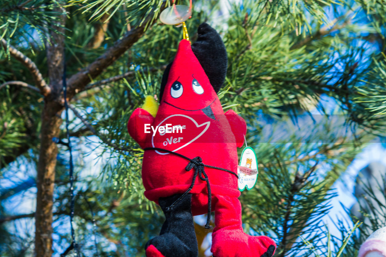 Low angle view of toy hanging on christmas tree