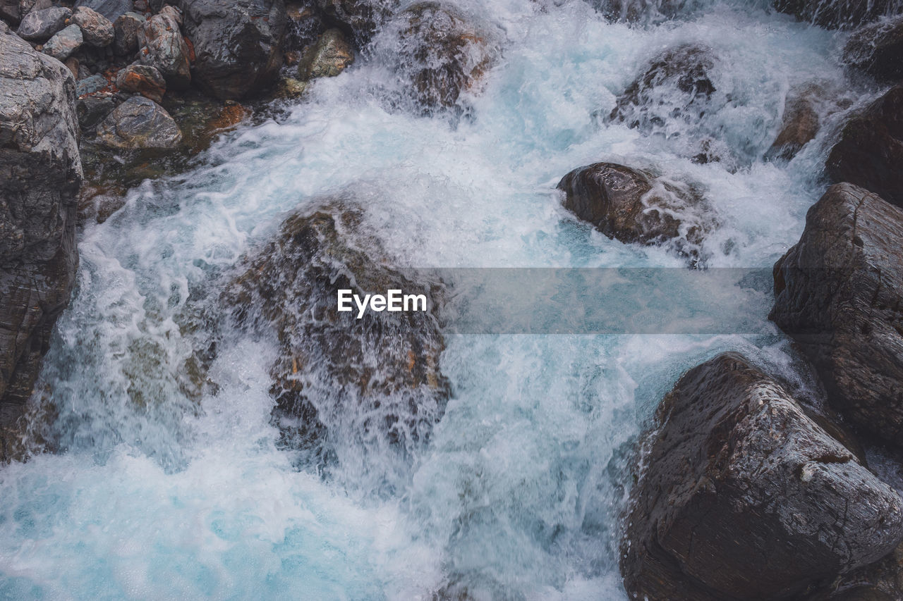 rapid, water, motion, rock, river, body of water, beauty in nature, nature, no people, wave, scenics - nature, high angle view, stream, sports, water feature, splashing, day, outdoors, water sports, waterfall, power in nature, wind wave, land, long exposure, watercourse, winter
