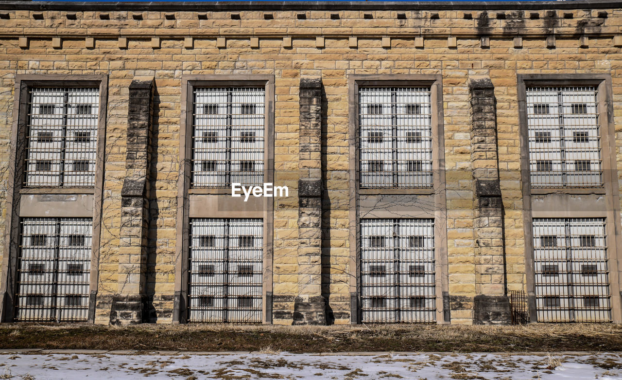 Abandoned prison brick wall and windows