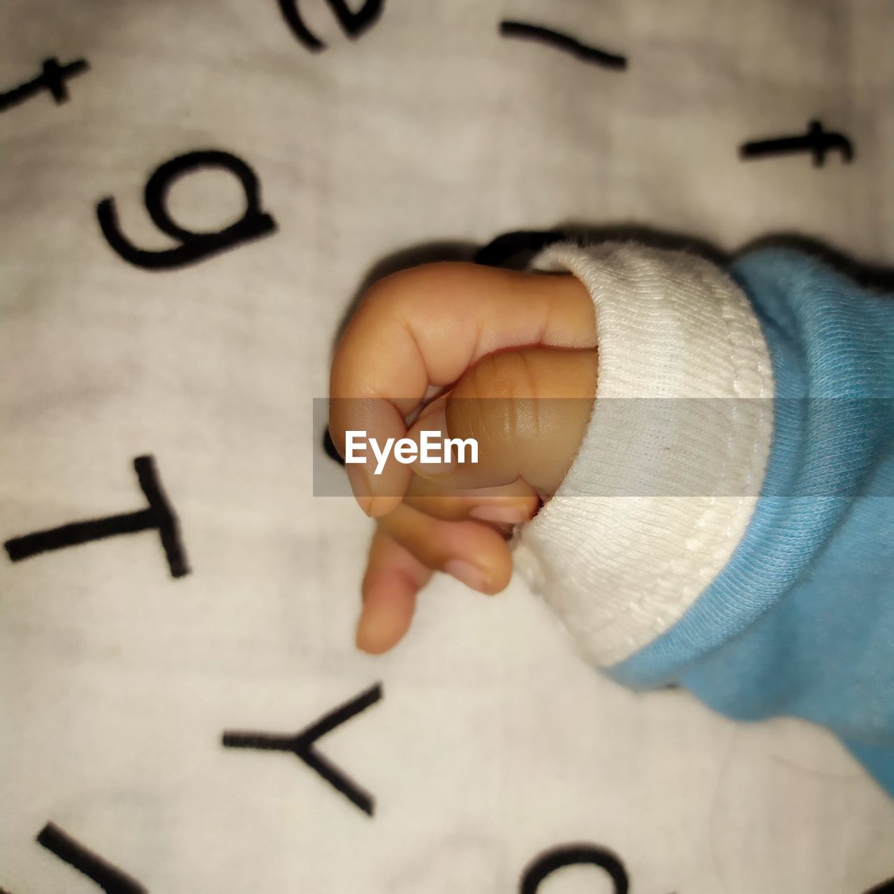HIGH ANGLE VIEW OF BABY HAND WITH TEXT