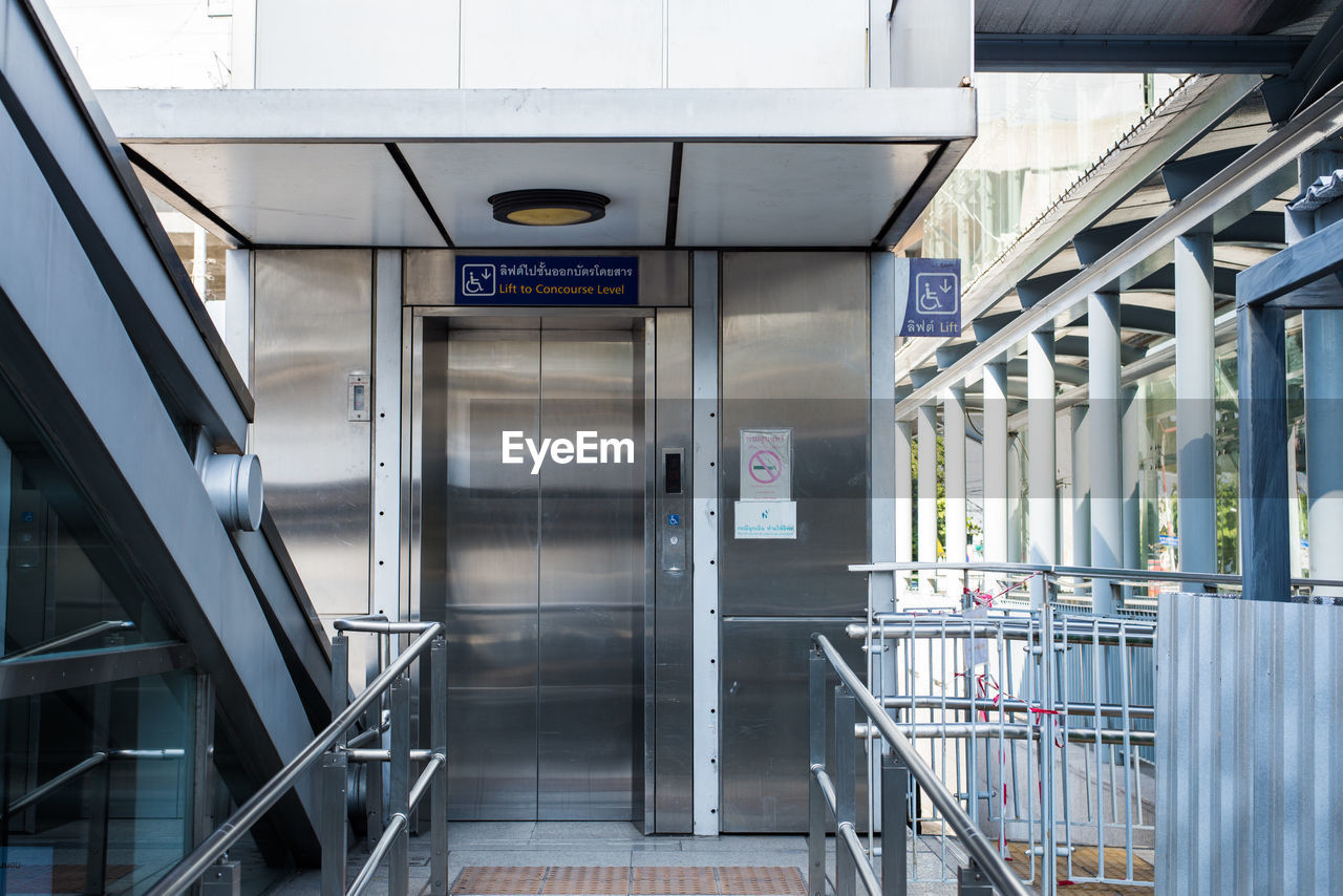 Pathway leading towards elevator in modern building