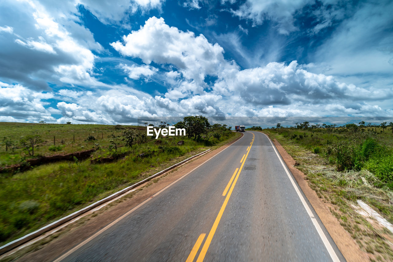 empty road amidst landscape against sky