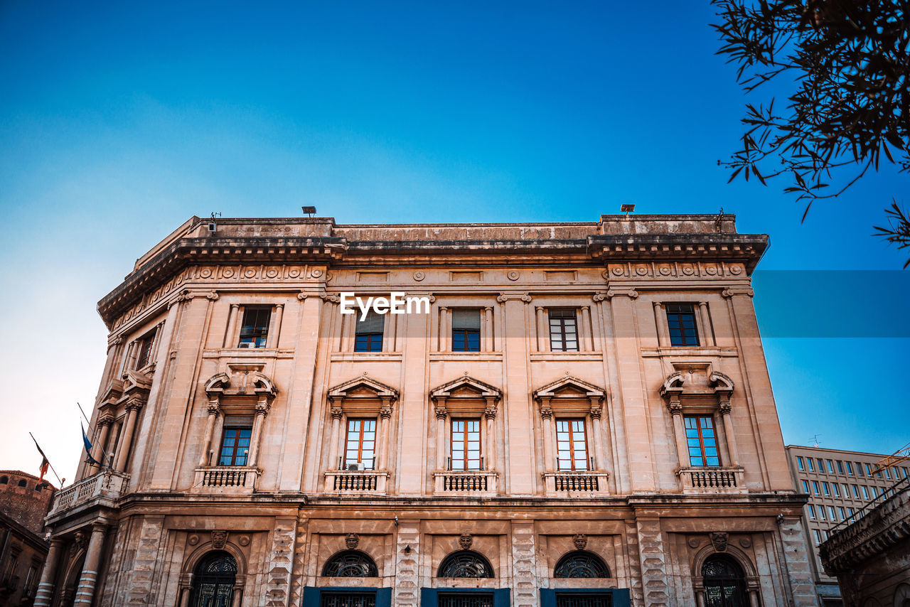 low angle view of historical building against clear blue sky