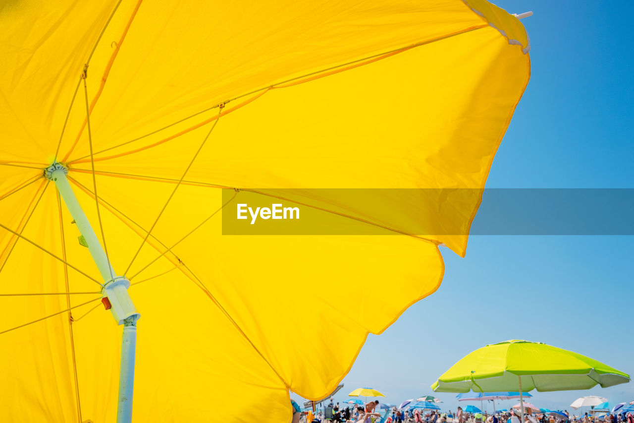 Parasol at beach on sunny day