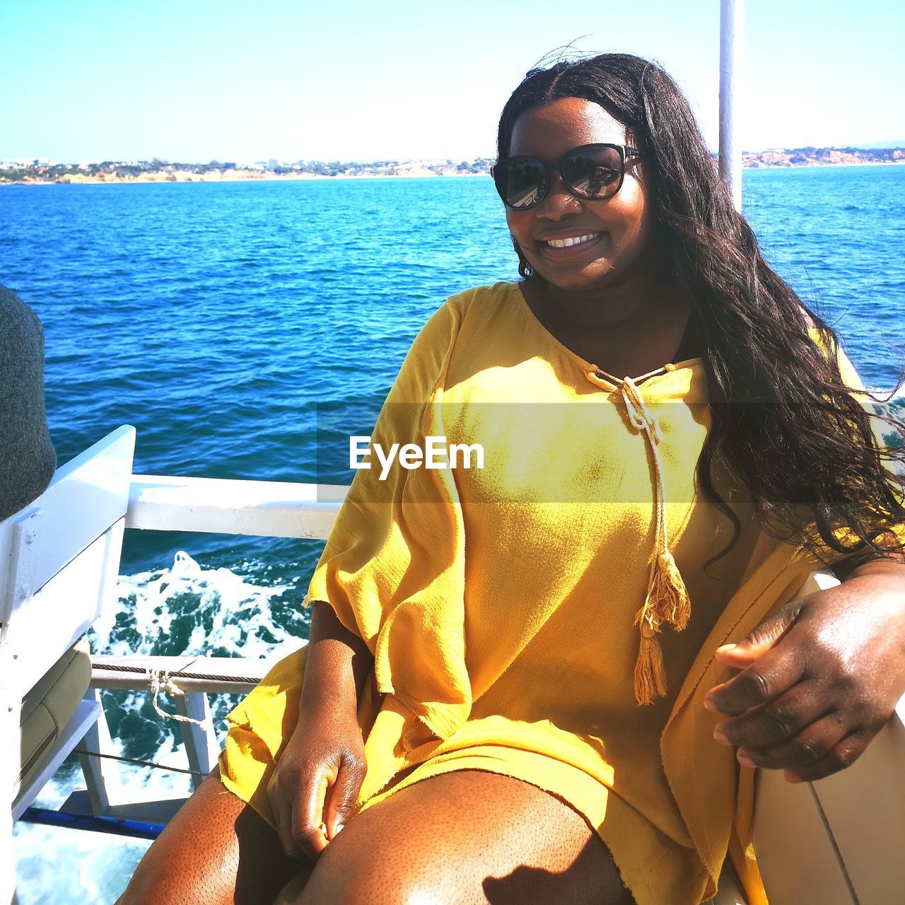 Portrait of smiling woman on boat in sea