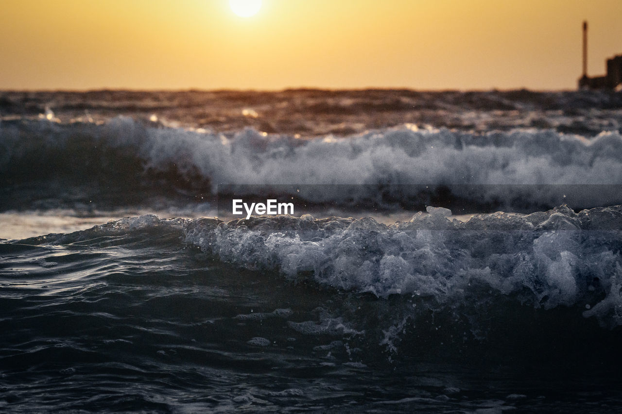 Close-up of sea waves during sunset