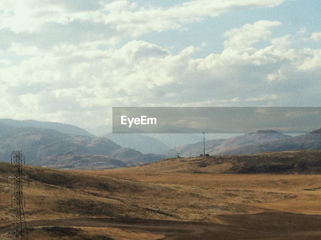 SCENIC VIEW OF MOUNTAINS AGAINST CLOUDY SKY