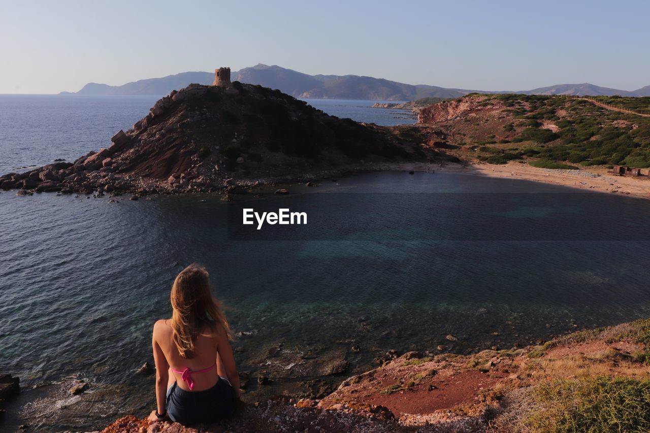 Rear view of woman looking at sea shore