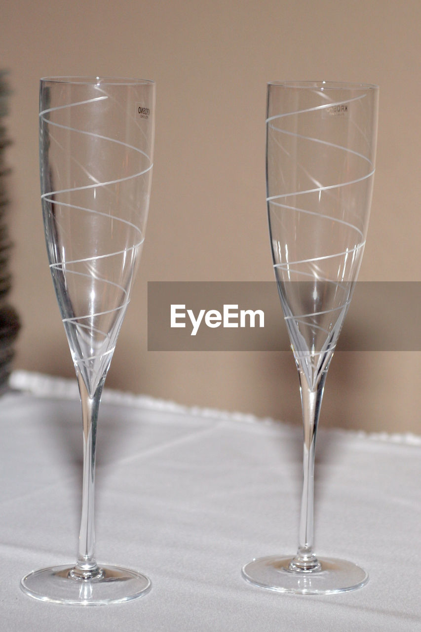 Close-up of empty champagne flutes on table