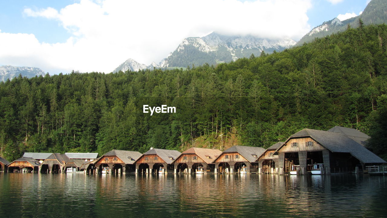 Boathouses in konigssee against trees