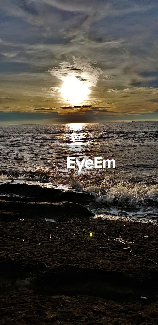 SCENIC VIEW OF BEACH DURING SUNSET