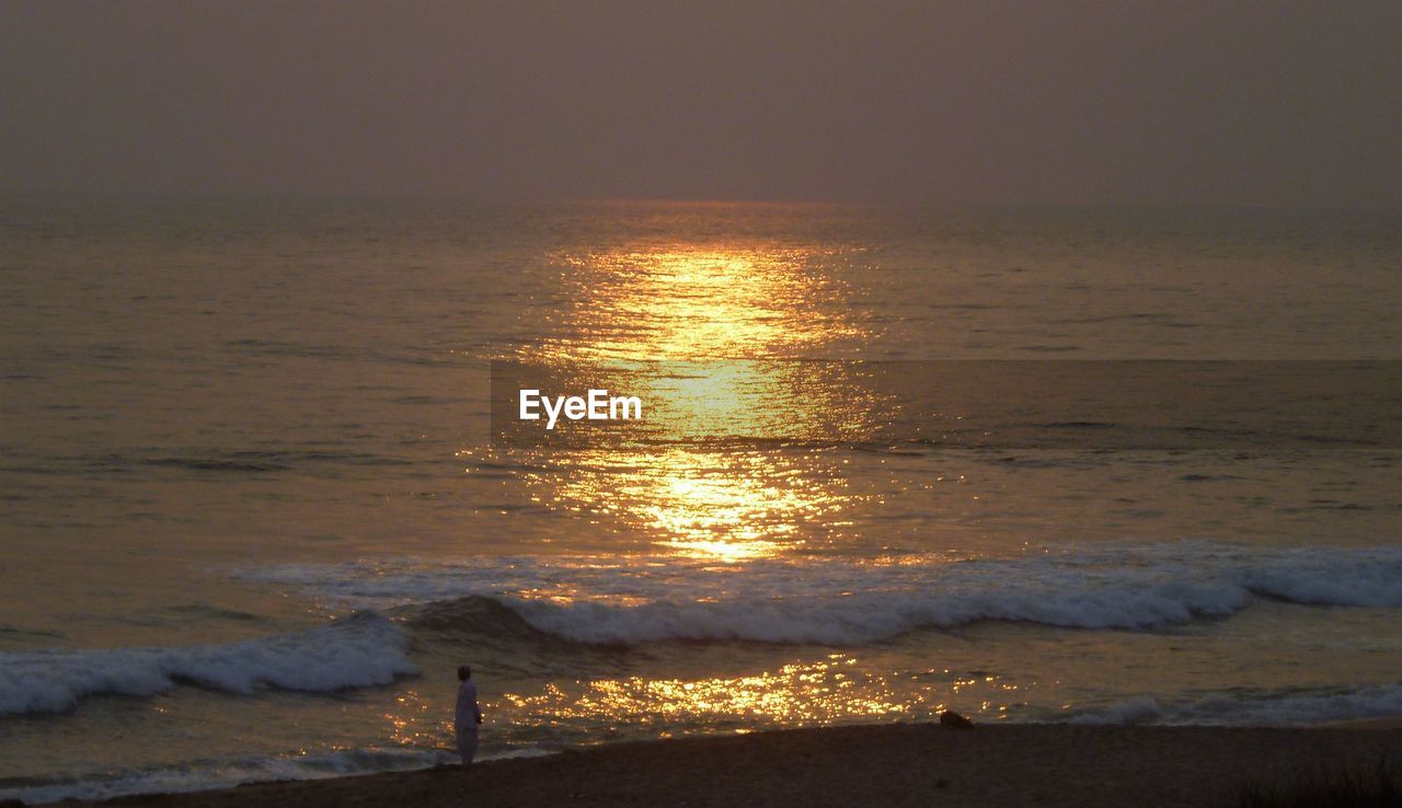 Close-up of sea against sky at sunset