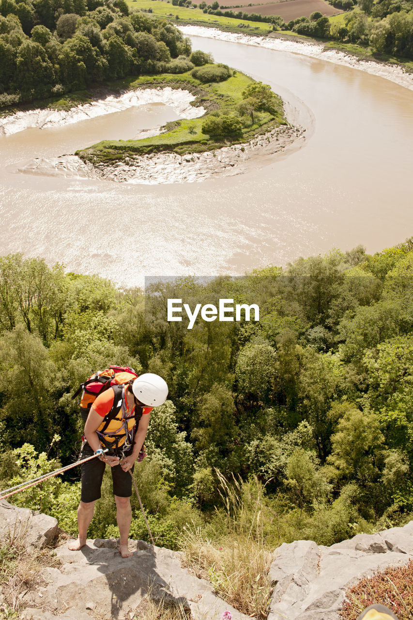 Woman rappelling of cliff in south wales